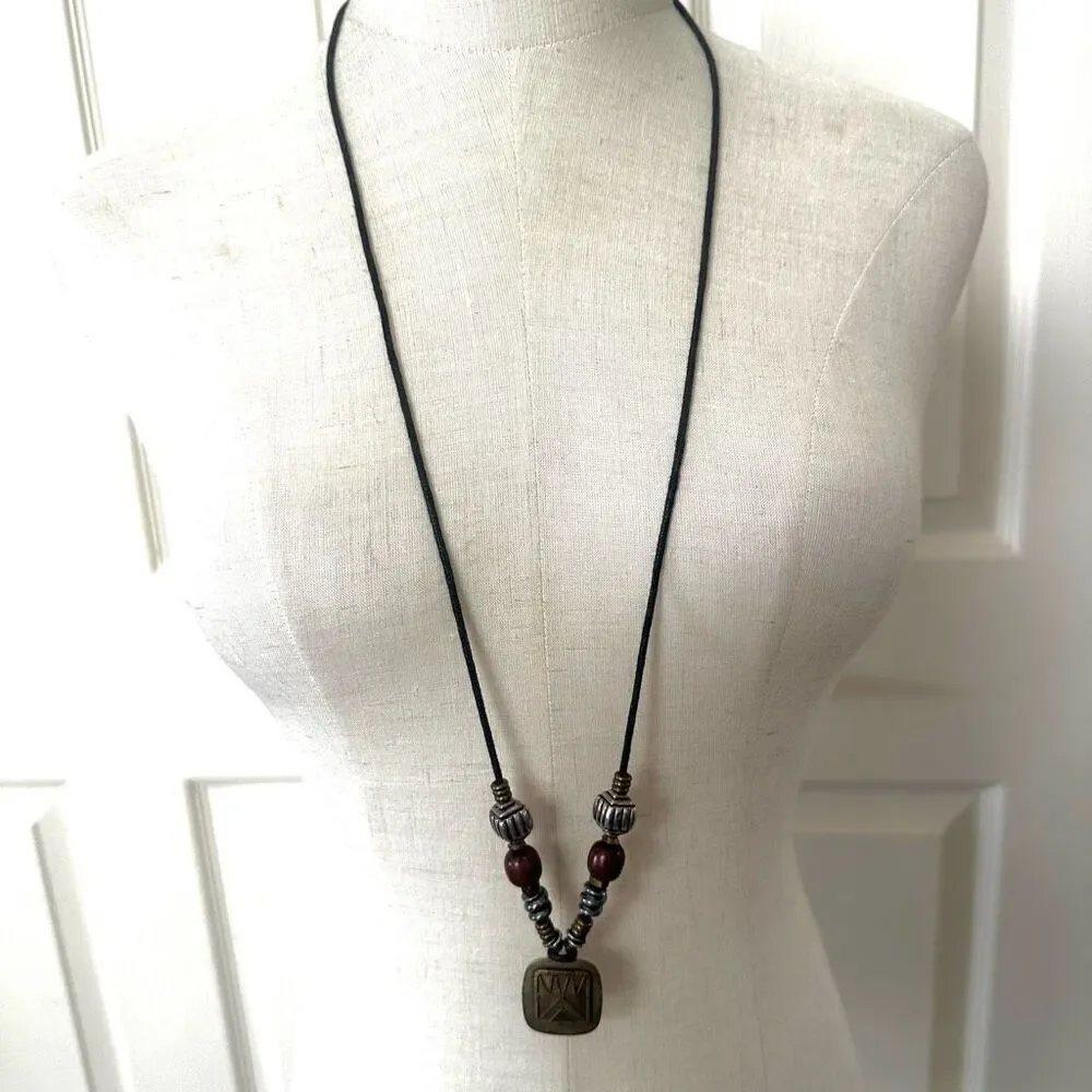 Baer SF sterling silver and brass pendant necklace on black cord